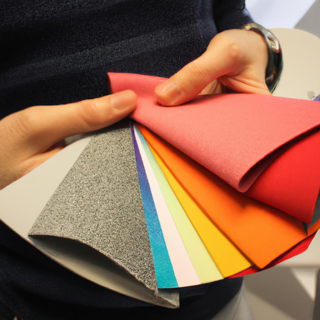 Person holding different fabric samples